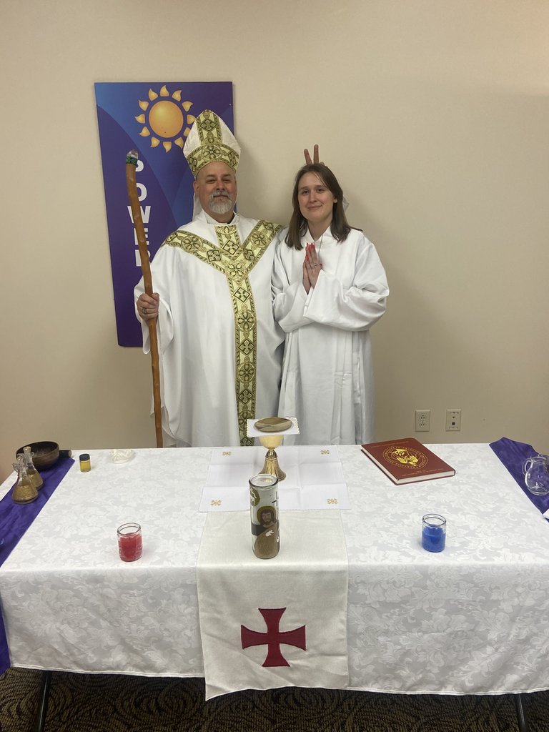 A bishop and a parishioner at the altar during a service.